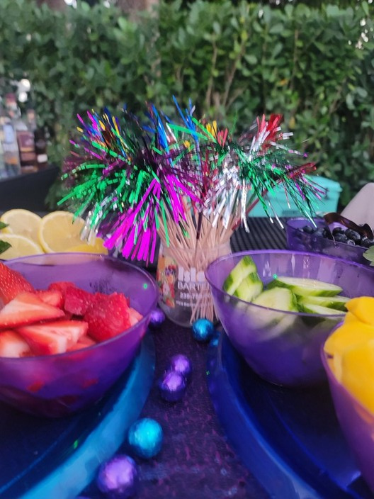 Colorful tropical party detail with fruit and props