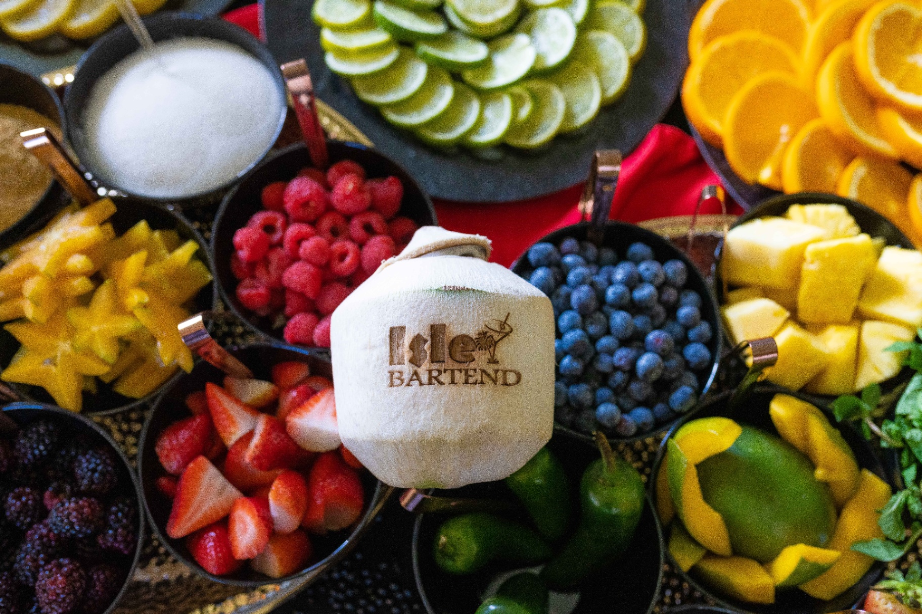Branded Isle Bartend coconut surrounded by fresh fruit